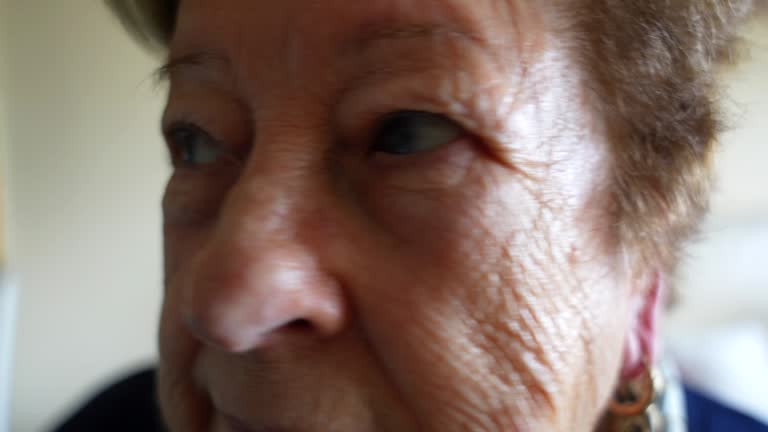 Closeup profile of old woman showing wrinkles on her face. Headshot