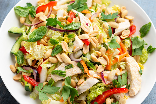 Healthy Vietnamese Chicken Salad with vegetables and peanuts photo