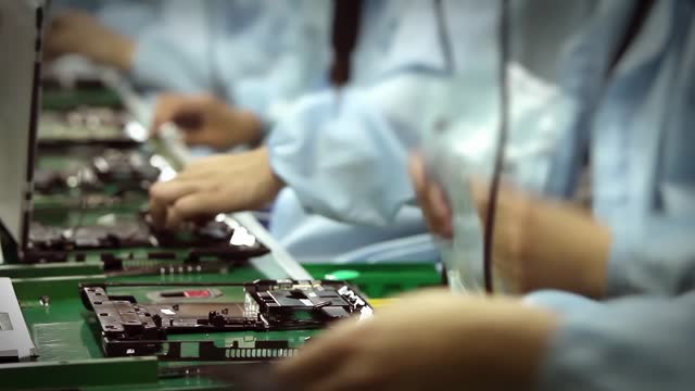 Assembly Line Workers Manufacturing Laptop Computers. Timelapse. Closeup. 4K Resolution.