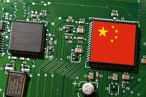 Flag of the Republic of China on microchip of a printed electronic circuit board. Concept for supremacy in global microchip and semiconductor manufacturing.