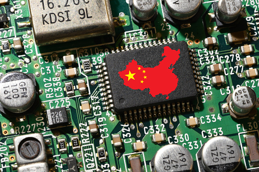 Map and Flag of the Republic of China on microchip of a printed electronic card. Concept for supremacy in global microchip and semiconductor manufacturing.