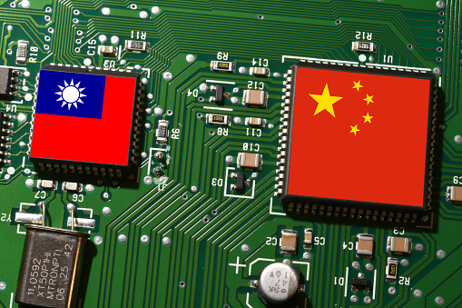 Flag of the Republic of China and Taiwan on microchips of a printed electronic circuit board. Concept for supremacy in global microchip and semiconductor manufacturing.