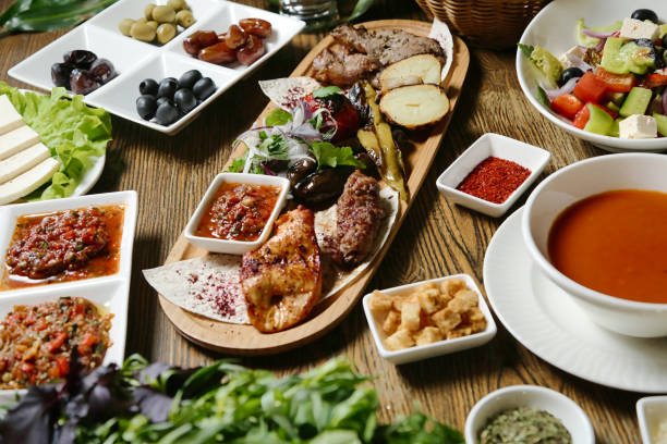 istock Wooden Table Displaying Plates of Delectable Food 2073396344
