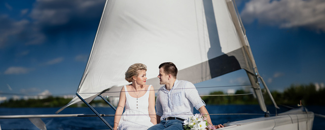 newlywed couple in love on a yacht at sea in the summer.