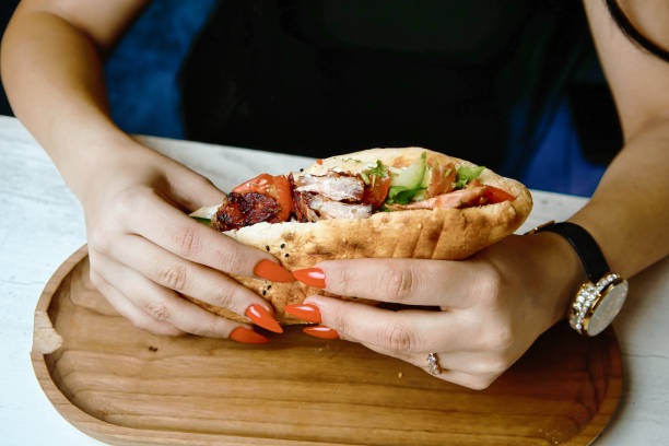 istock Woman Holding a Sandwich in Her Hands 2073435913