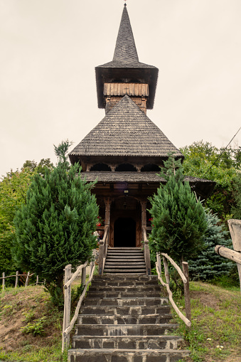 The Wooden Church in Maramures was built with high timber, and its characteristic features are the tall and slim bell towers located at the western end of the building. and massive roof.
