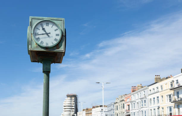 A public clock on the seafront A public clock on the seafront at St Leonards, East Sussex, UK. color image roman numeral rusty time stock pictures, royalty-free photos & images