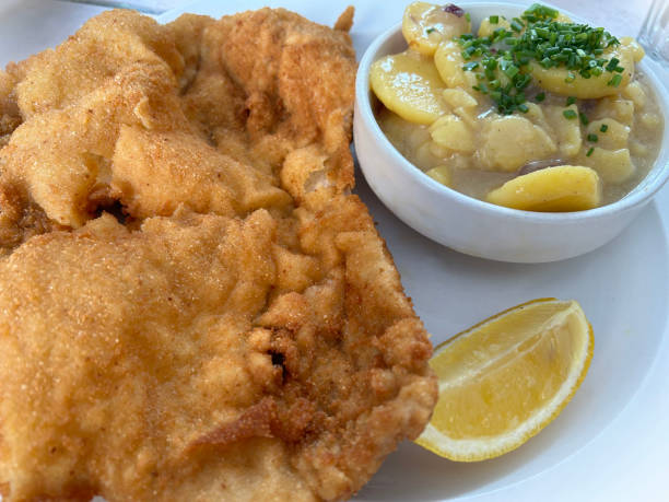 Wiener schnitzel with potato salad and chives.
