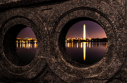 Framed and reflecting Washington Monument.