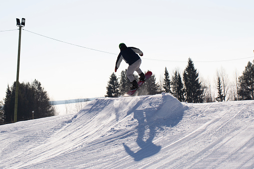 Syktyvkar, Komi Republic, Russia, March 10, 2024, A snowboarder rides a snowboard. Winter recreation.Snowboarding on the mountain.
