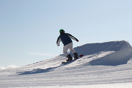 Syktyvkar, Komi Republic, Russia, March 10, 2024, A snowboarder rides a snowboard. Winter recreation.Snowboarding on the mountain.