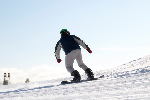 Syktyvkar, Komi Republic, Russia, March 10, 2024, A snowboarder rides a snowboard. Winter recreation.Snowboarding on the mountain.