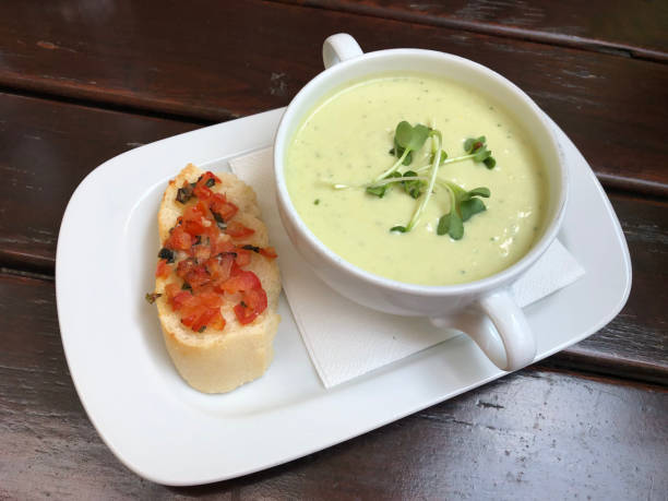 istock Vegetarian celery cream soup with ginger, served with classic bruschetta with tomatoes. 2073554933