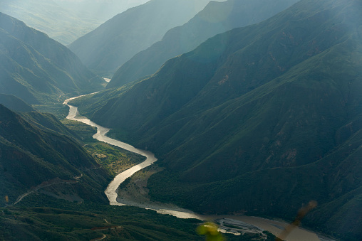 Chicamocha river flows through a canyon, mountainous Andean scenery in Santander, Colombia, at sunset.