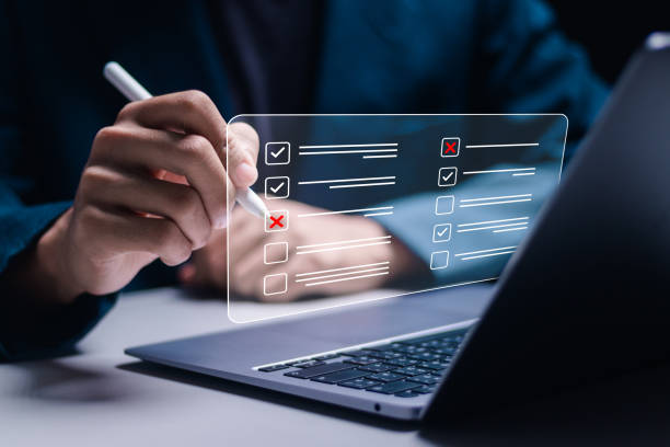 istock Questionnaire with checkboxes, Businessman use laptop with filling survey form online, answer questions of test. Survey form concept. Education futuristic technology and learning concept. 2073589634