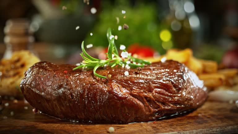Super Slow Motion of Flying Salt on Beef Steak.