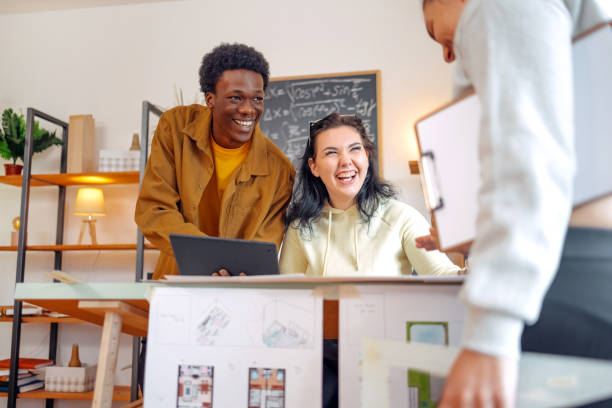 istock Group of young people working on project together at home 2073627767