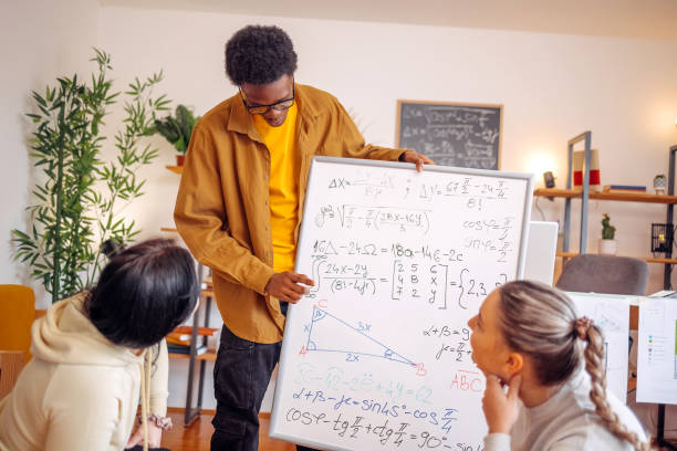 istock Group of young people working on project together at home 2073630928