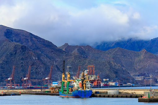 Cranes loading cargo ship in port of Santa Cruz de Tenerife.