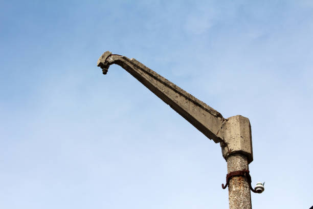 The arm of the machine lifts floor slabs in building construction.