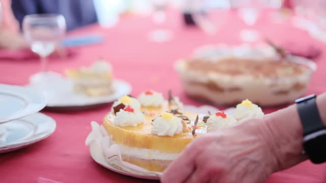 Cropped video of people cutting and eating sweet delicious cakes at table