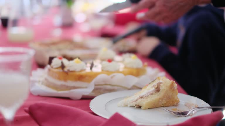 Cropped video of people cutting and eating sweet delicious cakes at table