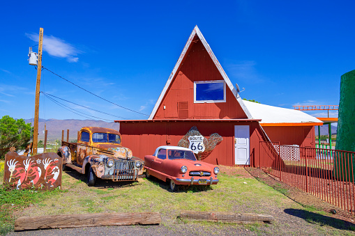 Antares,  Arizona, United States - September 22, 2023: Wooden building with vintage parked cars in front.