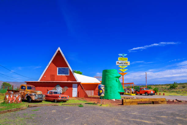 A rustic red barn at night, illuminated by one light.  Summer time night feel of rural Missouri.