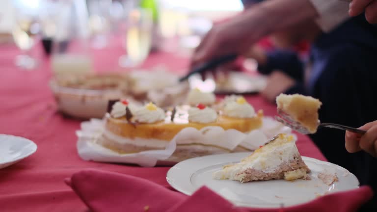 Cropped video of people cutting and eating sweet delicious cakes at table