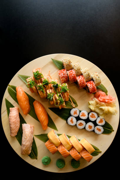 istock Assorted sushi rolls on a round wooden board 2073712790