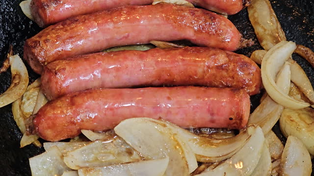 frying sausages with onions