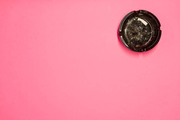 istock Black glass ashtray and a cigarette butt in it 2073815931