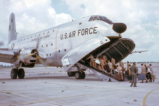 Waterloo, Iowa, USA - 1963: US Air Force C-124 military cargo airplane with cargo bay open and loading reserves for yearly training. Scanned film.