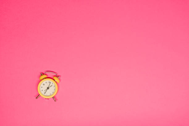 Daylight savings time. Clocks spring forward. Red clock on tree branches