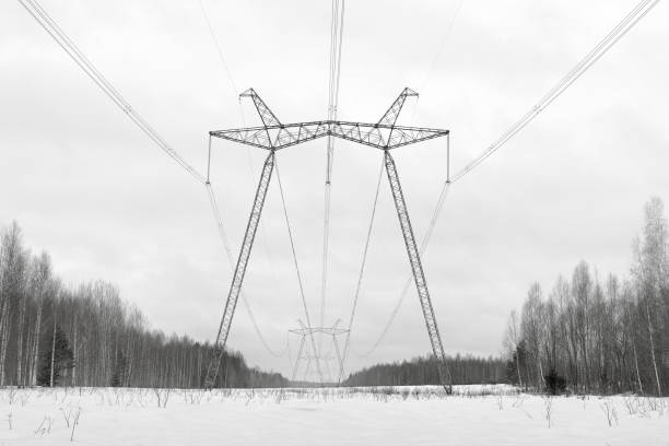 Power line supports stretching into the distance. Powerful power line wires.