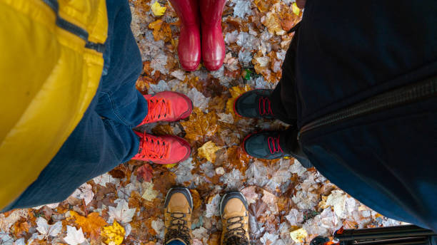 istock Hiking boots on top of colorful fall tree leaves 2073840368