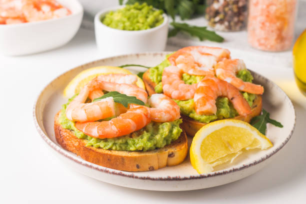 istock Shrimps on toast with avocado and lemon. Breakfast concept. Bruschetta. 2073858792