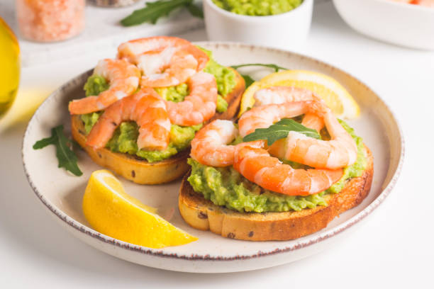 istock Shrimps on toast with avocado and lemon. Breakfast concept. Bruschetta. 2073858797