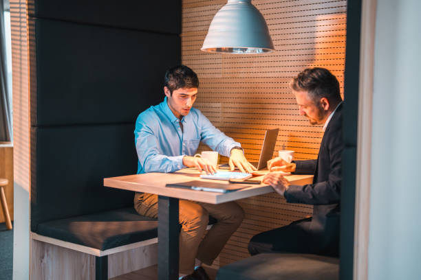 istock Professional Meeting with Two Diverse Businessmen Discussing Over Documents 2073859386