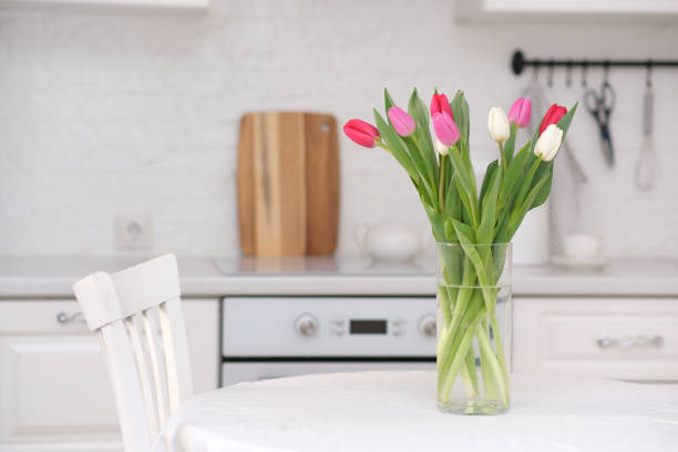istock Home kitchen interior.Vase with bouquet of pink, white tulips on table at the kitchen. Spring consept. 2073872132