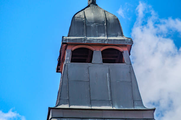An ancient Gothic tower. A black tower with a tip, a place for archers, for defense under blue sky. Kharkiv Ukraine 05-05-2023