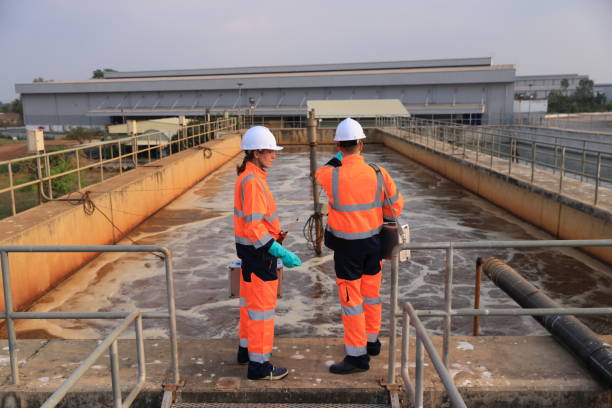 istock male and female environmentalist engineers work on concrete for wastewater treatment.Recycling and Ecology concept. Waste processing and water treatment plant 2073930532