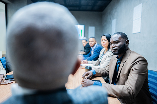 Mature businessman during a meeting with coworkers in the meeting room