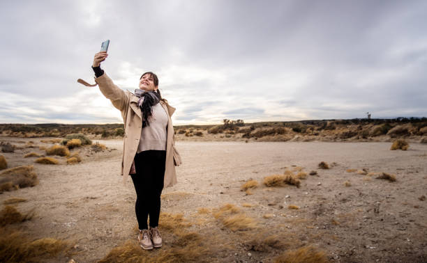 Young woman taking selfies in Argentinian Patagonia