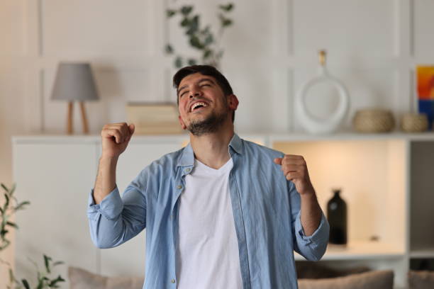 istock Young man singing and dancing at home 2073975405