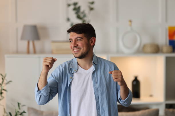 istock Young man singing and dancing at home 2073975940