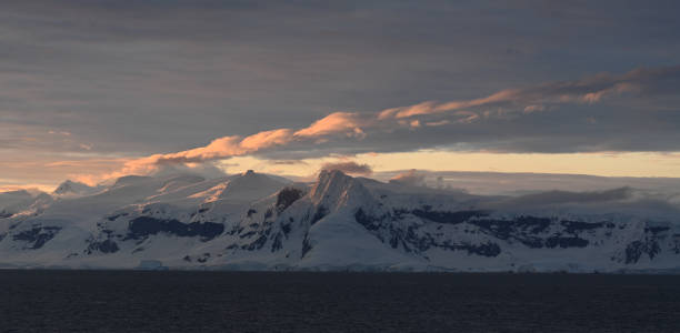 istock Glowing clouds at sunset, antarctic sea 2073976459