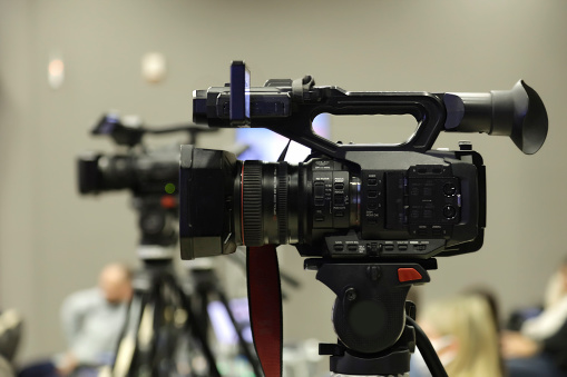 Professional Video cameras   - TV cams  in a row in a press conference