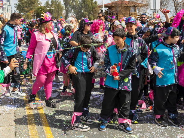 Limassol, Cyprus, March 10th, 2024: Boys having fun with silly string at Children’s Carnival Parade