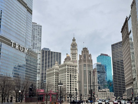 urban landscape of chicago with its buildings and skyscrapers of the city center which line a street as well as the trump tower which dominates under a cloudy winter sky